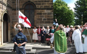 The Flagpole and Flag are blest as the St George's Flag flies for the first time on the new Flagpole.
